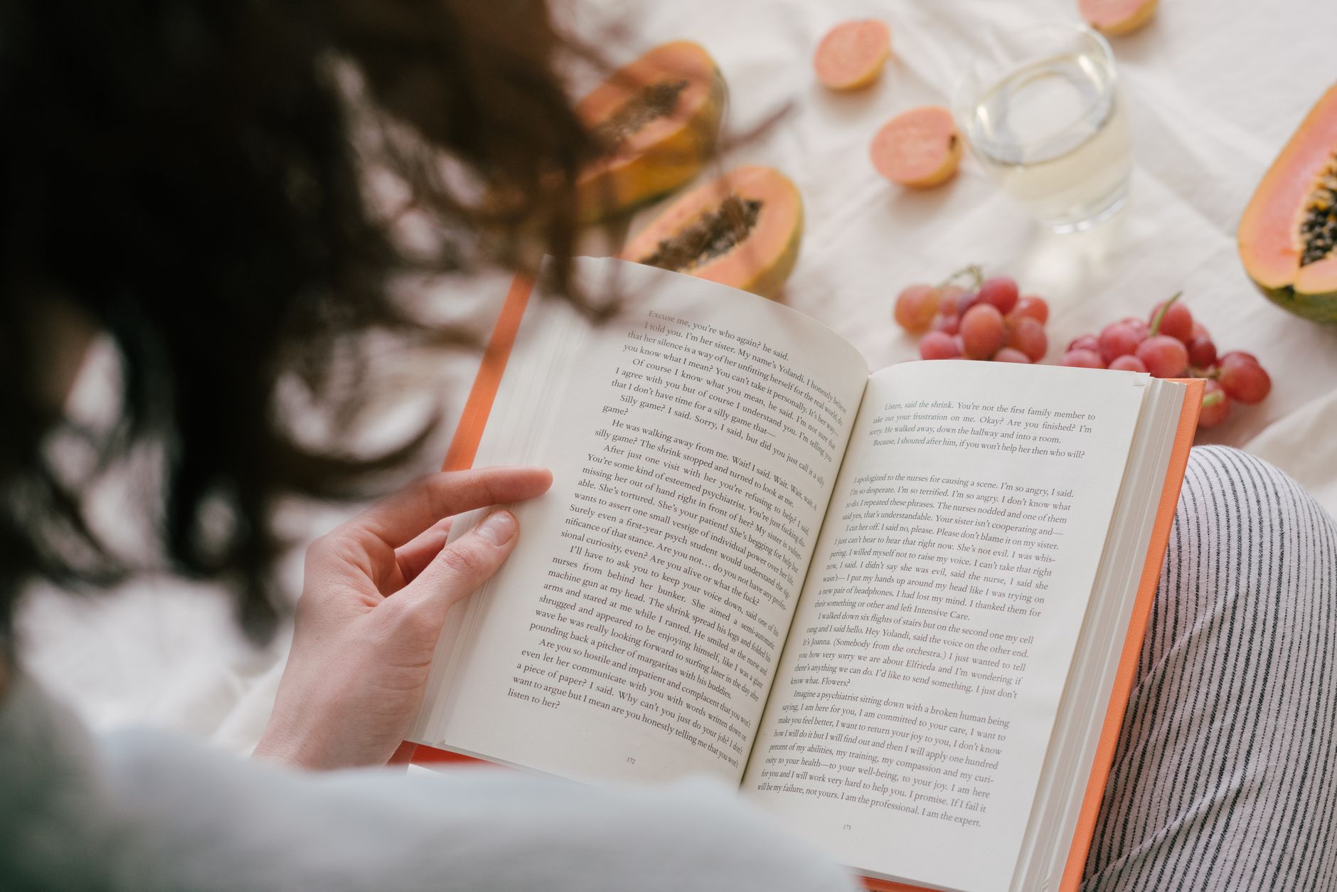 person reading book relaxing