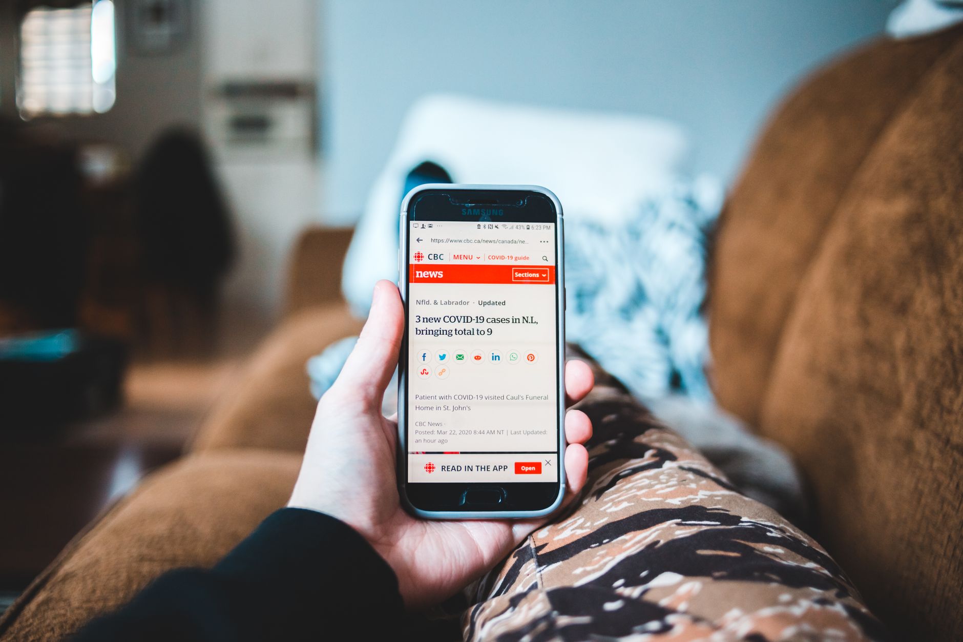 person reading smartphone news