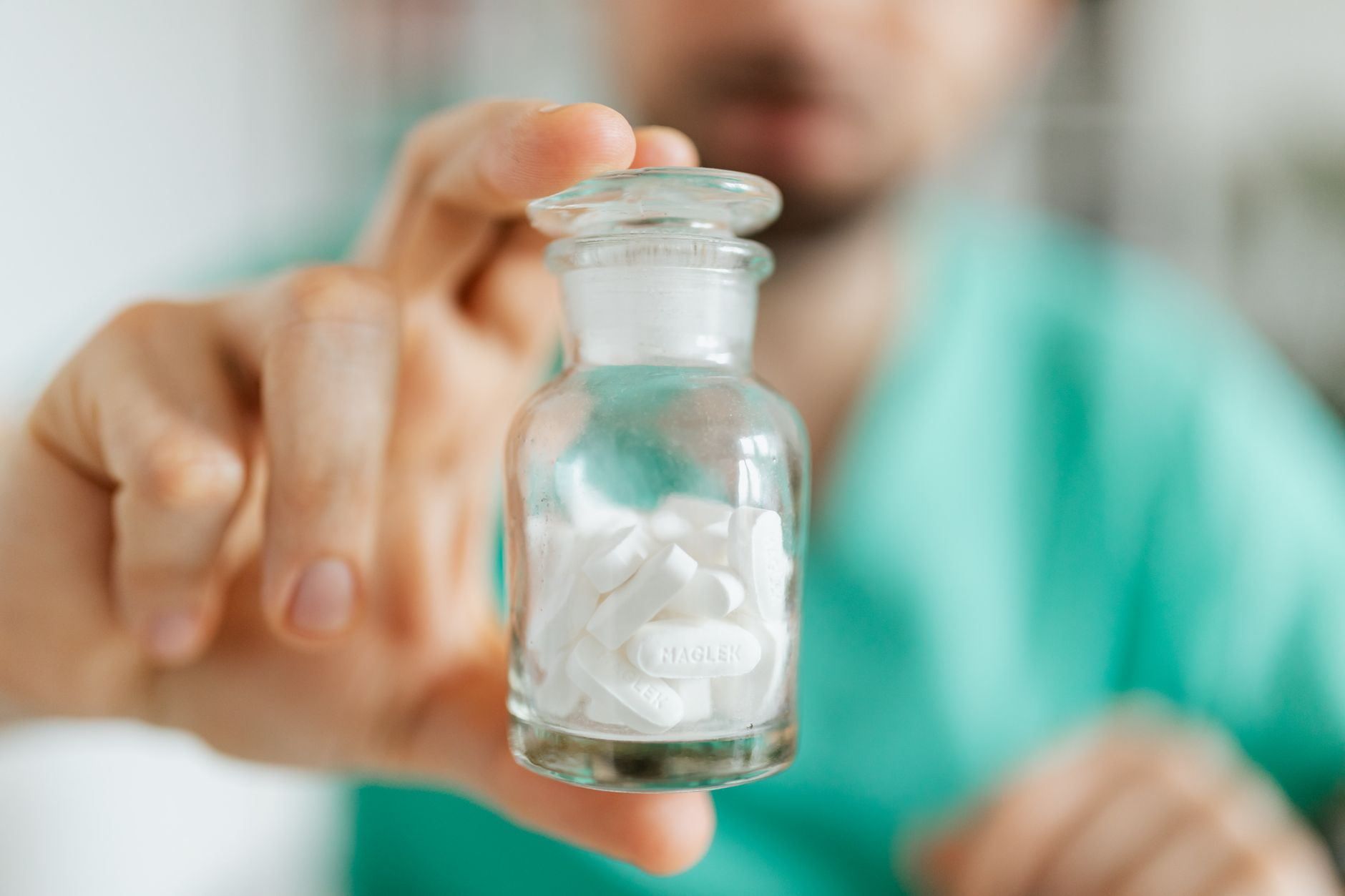 pharmacist holding medication bottle